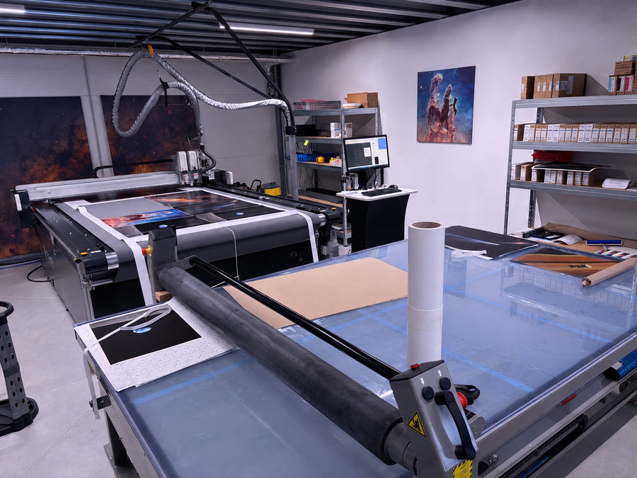 Astrography production studio with a flatbed cutter, laminator and space prints.